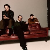 Skinny Living sat on a red leather coach